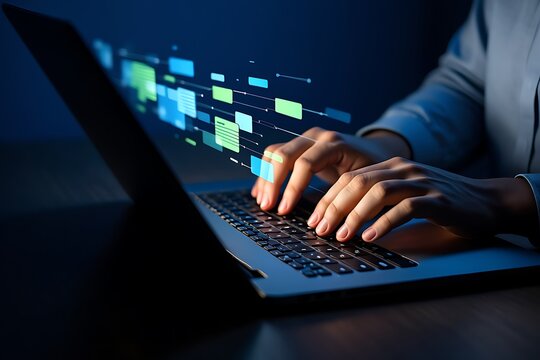 Woman working on a laptop with hands typing on the keyboard in an office setting