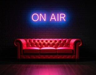 Vivid neon sign glows over a red couch against a brick wall