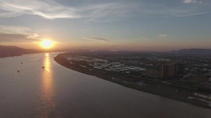 Beautiful sunset over the river with breathtaking views of the landscape and city skyline at twilight