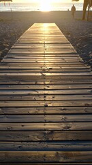 Wooden walkway bathed in golden sunlight leading towards the ocean