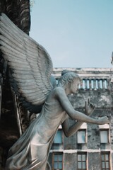 A classical angel statue stands against the backdrop of Rasamadu Heritage in Surakarta. Surrounded by European-style architecture and historical charm, the sculpture reflects the site's colonial past 