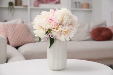 Bouquet of beautiful peonies on table indoors