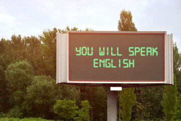 You Will Speak English text on digital billboard outdoors. Language course