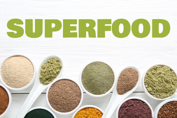 Superfood. Different powders and flaxseeds on white wooden table, flat lay