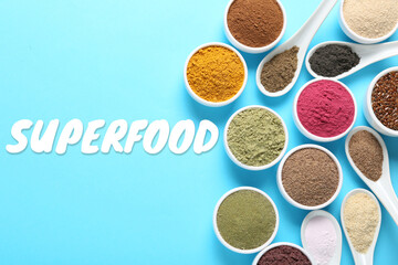 Superfood. Different powders in bowls and spoons on light blue background, flat lay