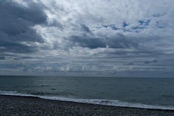 Pebble beach and stormy sky at the Black Sea. Stormy sky over the sea. Nature composition of stormy clouds.