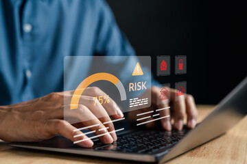 Online transaction risk warning on laptop with risk meter, cyber threat icons, financial alert...