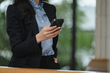 Businesswoman using mobile phone in office building