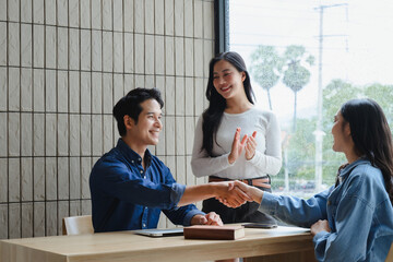 Asian businesspeople shaking hands during a meeting