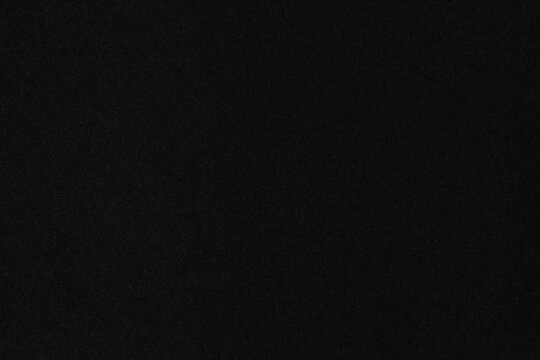 Black matte paper texture background with soft grain. Ideal for dark theme design, luxury branding, minimal presentations, or dramatic contrast compositions.