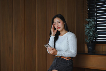 Young Asian Woman Suffering From Headache While Using Smartphone