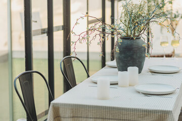 Elegant Outdoor Dining Setting with Natural Light and Floral Arrangement