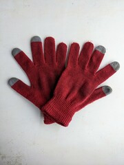 Pair of red touchscreen gloves isolated on a white background. Winter clothing and technology concept.