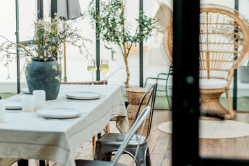 Elegant Outdoor Dining Setting with Natural Light and Floral Arrangement