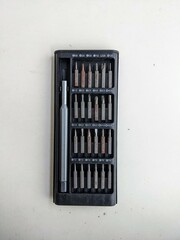 Precision screwdriver set with multiple interchangeable bits in a case. Toolkit for electronics, phone, and computer repair.