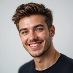 the image presents a close up portrait of a person, angled slightly towards the viewer. the person displays a large smile, showing their teeth. they have short, styled hair and light stubble