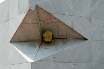 Artillery shell embedded in a granite architectural structure, part of a military memorial. Viewed...