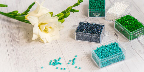 Colorful glass beads with flowers. Variety of shapes and colors to make a bead necklace or a string of beads for women