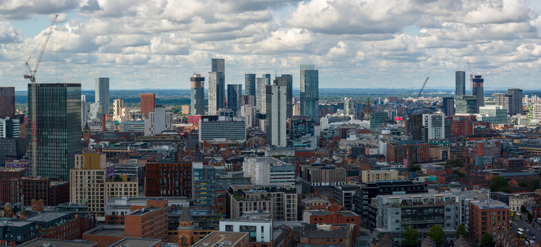 Panoramic aerial view of Manchester skyline with modern high-rise buildings photographed over Ancoats. 