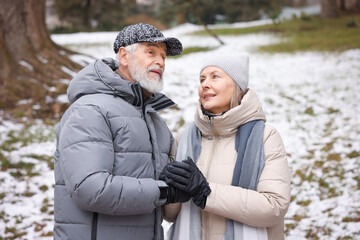 Fototapeta premium Lovely senior couple holding hands at winter park