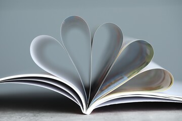 One open magazine on grey table, closeup