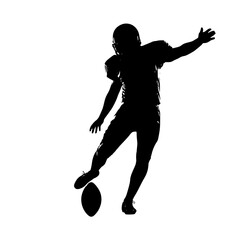 Silhouette of American Football Player Kicking the Ball During a Game