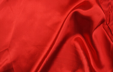 Rich red satin fabric draped elegantly across a surface.