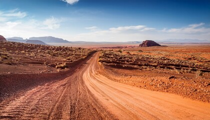 a scenic dirt road cutting through a barren desert landscape