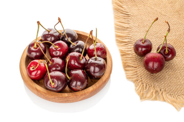 Sweet cherries on a wooden plate, macro.