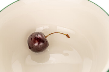 Sweet cherries on a ceramic plate, macro.