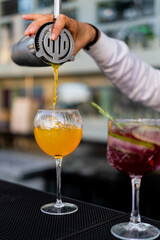 Bartender mixing and serving cocktails