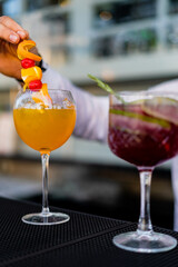 Bartender mixing and serving cocktails