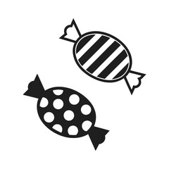Two black candies with white patterns on white background candy sweet
