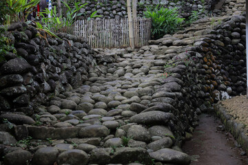 Stone Pathway. Traditional stone pathway in a rural Indonesian village. The path is made of large,...
