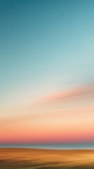 Fototapeta premium A serene landscape featuring a beach at sunset with a gradient sky of blue and orange hues