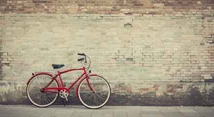 Red Bicycle Leaning Against Weathered Brick Wall, Urban Scene.