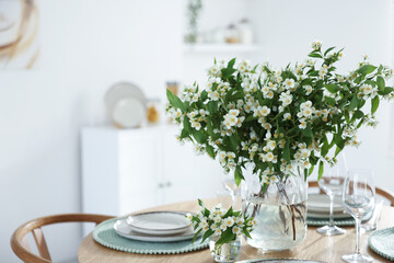 Bouquet of beautiful jasmine flowers on dining table indoors. Space for text