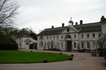 Shugborough, Staffordshire, England – February 24 2024: Historic white stable courtyard with...