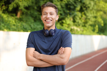 Portrait of sportsman with headphones at stadium