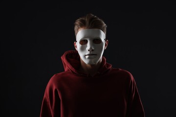 Anonymity. Man wearing mask on dark background