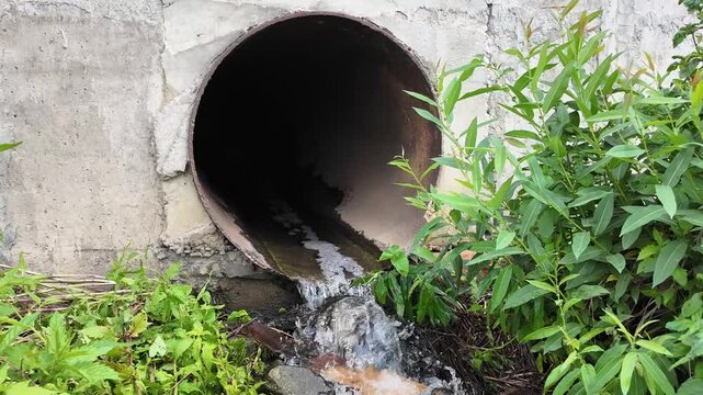 Water flowing from a drainage pipe into a small creek