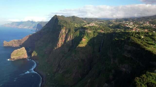 Madeira island beautiful nature scenic landscape. Aerial drone 4k hd video of Santana town and cliff Rocha do Navio over sunset with two waterfalls. portugal