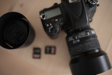 Camera with lens and flash drives. brown background