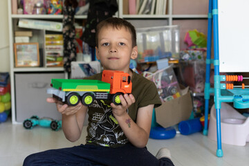 Boy with a truck in his hands. A boy holding a truck in his hands