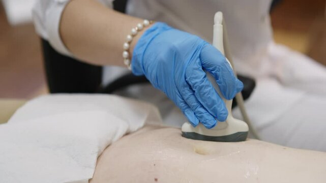 Young pregnant woman undergoing ultrasound diagnosis at clinic. Concept early pregnancy monitoring and fetal health
