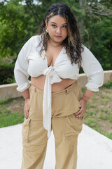 Fashion model posing outdoors, embracing body positivity and plus-size confidence