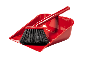 Red dustpan and brush cleaning tools isolated on black background.