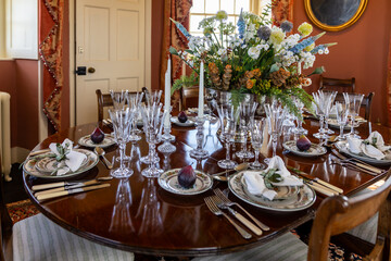 Elegant table setting with figs and flowers in a luxurious dining room
