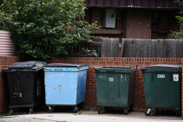 Four dumpsters waiting for pickup.