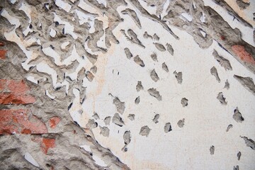 The texture of a brick wall with applied plaster